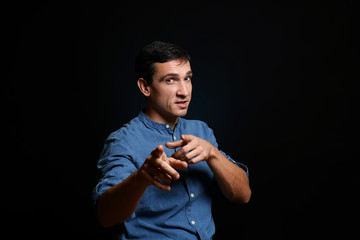 Attractive young man on black background