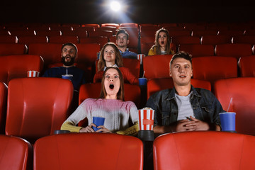 Fototapeta premium Young people watching movie in cinema
