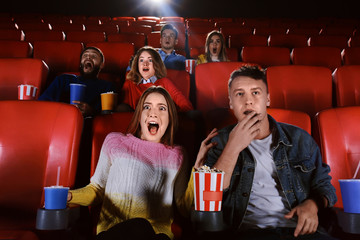 Fototapeta premium Young people watching movie in cinema