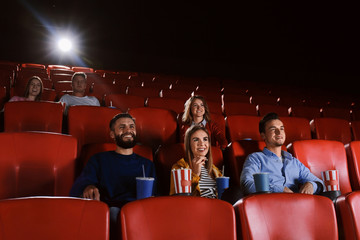 Young people watching movie in cinema