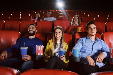 Young people watching movie in cinema © Africa Studio