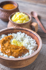 Bowl of rice with Indian butter sauce and Ghee clarified butter