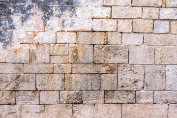 Brick wall background with remains of plaster