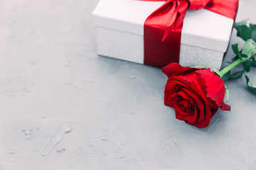 Beautiful red rose and gift box on wooden background with copy space. valentine's day present.