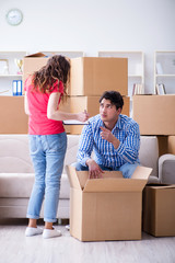 Fototapeta na wymiar Young pair moving in to new house with boxes