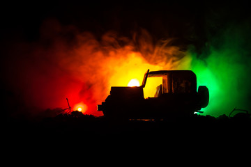 War Concept. Military silhouettes fighting scene on war fog sky background, World War Soldiers Silhouettes Below Cloudy Skyline At night. Attack scene. Army jeep vehicles with soldiers
