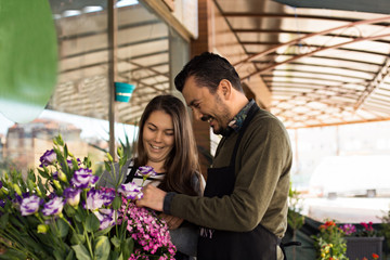 Florist couple working in a flower shop