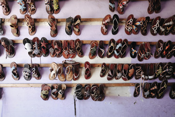 Hand made production by artisans. Typical shoes shop in Watamu, Kenya.