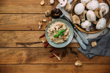 Fototapeta na wymiar Mushroom risotto, with champignons on a dark rustic texture
