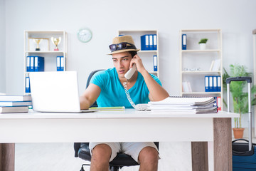 Businessman preparing for vacation in the office