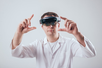 Doctor uses augmented reality goggles.