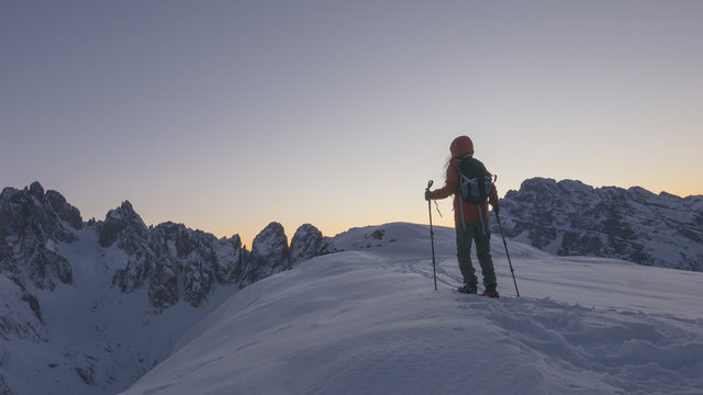 Brave woman explorer hiking at the top of the glacier, vintage effect