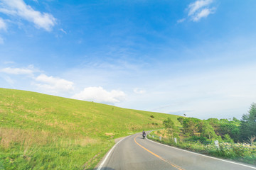 Beautiful  landscape view of  a country road and green grass with  blue sky  background of Utsukushigahara park is  one of the most important and popular natural place in Nagano Prefecture , Japan.