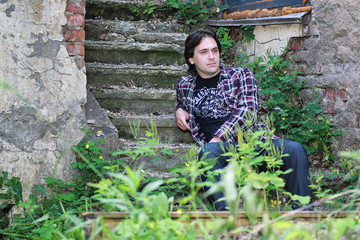 man sit on abandoned stair