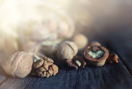 walnuts, whole and peeled wooden background