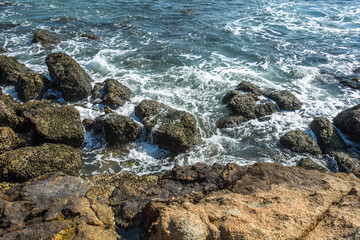 Fototapeta na wymiar Sea waves splash on stones.