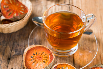 Bael tea juice on wooden table , healthy drink