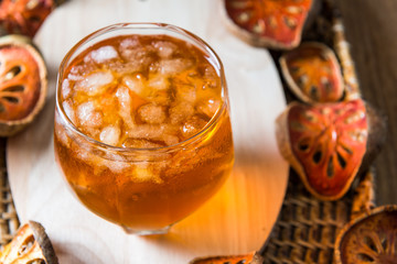 Bael juice ice tea on wooden table , healthy drink