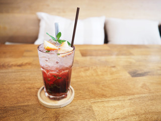 glass of strawberry juice with soda on wooden table