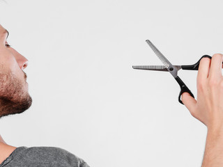 Man with scissors texturizing or thinning shears