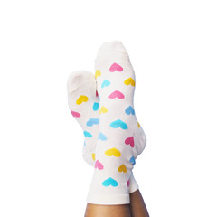 feet wearing white socks with pastel heart shape pattern on white background