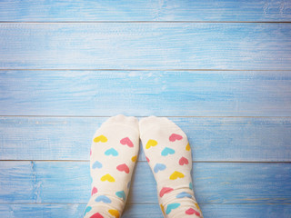 Selfie feet wearing white socks with pastel heart shape pattern