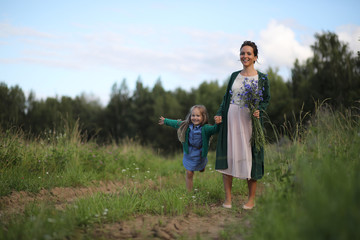 Mother with daughter walking on a road