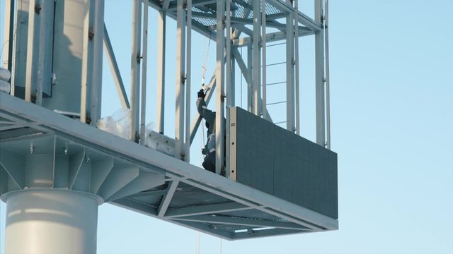 People Working Building New Big Billboard. Worker repairing billboard