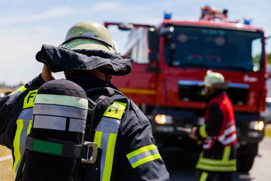 german fireman ( Feuerwehr ) stands near an accident