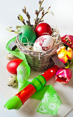Traditional Czech easter decoration - my handmade painted eggs with daffodils flower quail eggs green ribbon and wooden music instrument flute. Spring easter holiday arrangement.