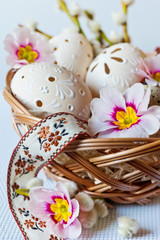 Czech traditional easter decoration, my own homemade laced white eggs in the nest with flowers and ribbon