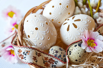 Czech traditional easter decoration, my own homemade laced white eggs in the nest with flowers and ribbon