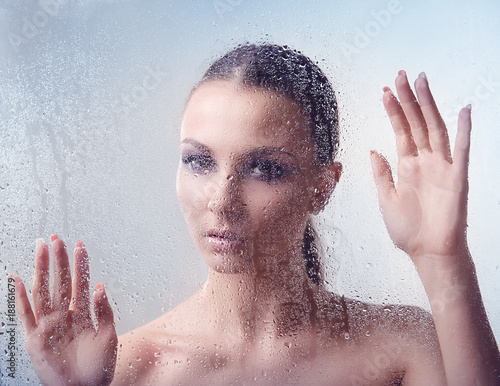 Brunette Woman With Makeup Smoky Eyes Behind Glass With
