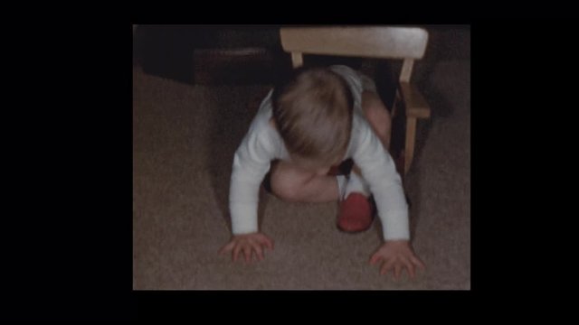 1953 Toddler in red shoes climbs into baby chair