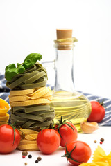 Italian Pasta with tomatoes, olive oil, basil, garlic and pepper on a white background. Copyspace