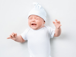 Crying newborn baby on white background