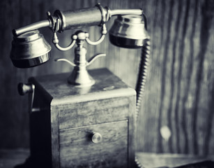 Old telephone and retro book on the desk. The phone of the past 