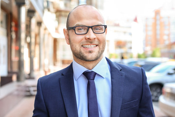 Fototapeta premium Young man in suit, outdoors