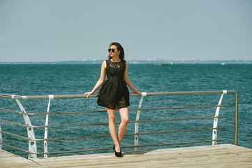 Fototapeta na wymiar young beautiful woman on a walk near the sea