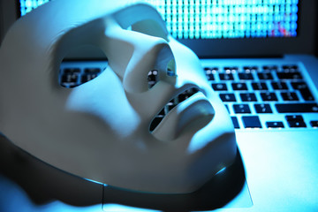 White mask on laptop keyboard, closeup