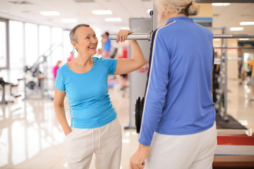 Fototapeta na wymiar Elderly people in modern gym