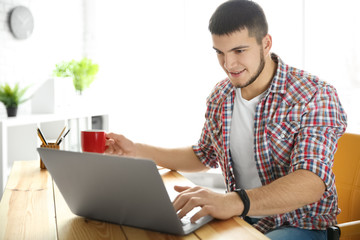 Young man using laptop at home