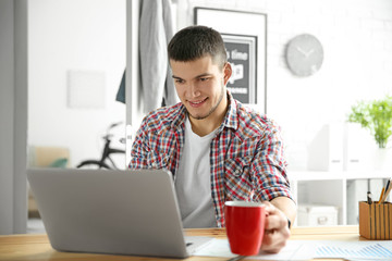 Young man using laptop at home