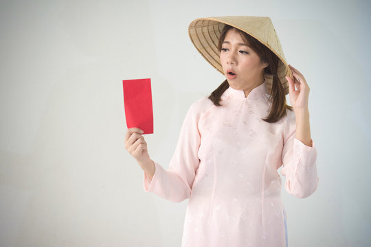 Vietnam woman holding red envelope, woman wear Vietnamese, Vietnamese new year