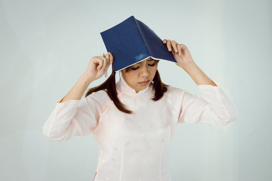 Young Asian woman got headache read a book