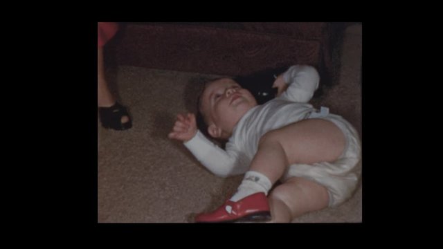 1953 Pretty mother plays and flips over toddler son