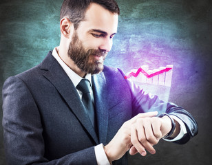Businessman touching virtual graphic icon from smartwatch.