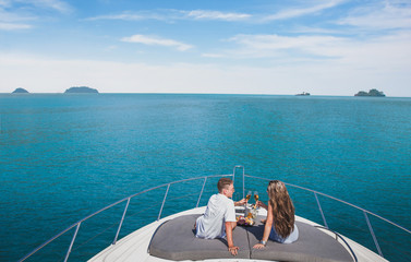 couple drinking champagne on luxury yacht cruise, luxurious lifestyle