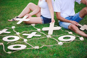 Boy and girl playing tic-tac-toe in the park