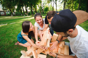 Friends playing board game outdoors.
